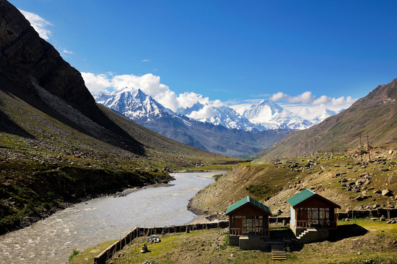 Stunning landscape of Ladakh mountains with a river and huts in summer.