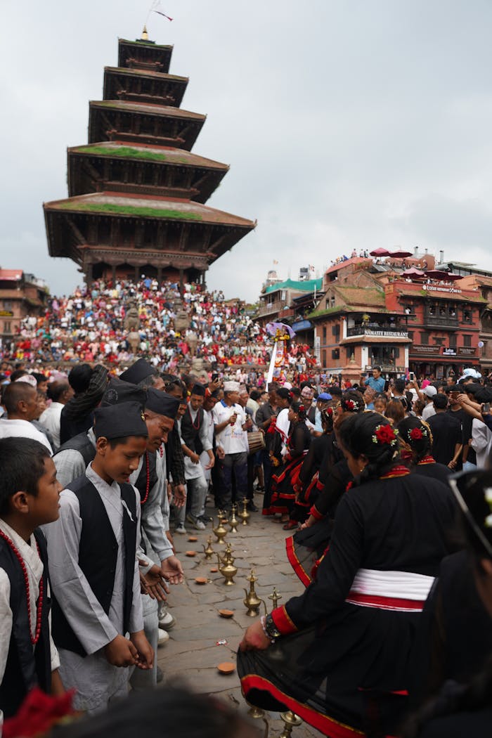 Crowds gather for a vibrant cultural festival in Bhaktapur, featuring traditional attire and rituals.